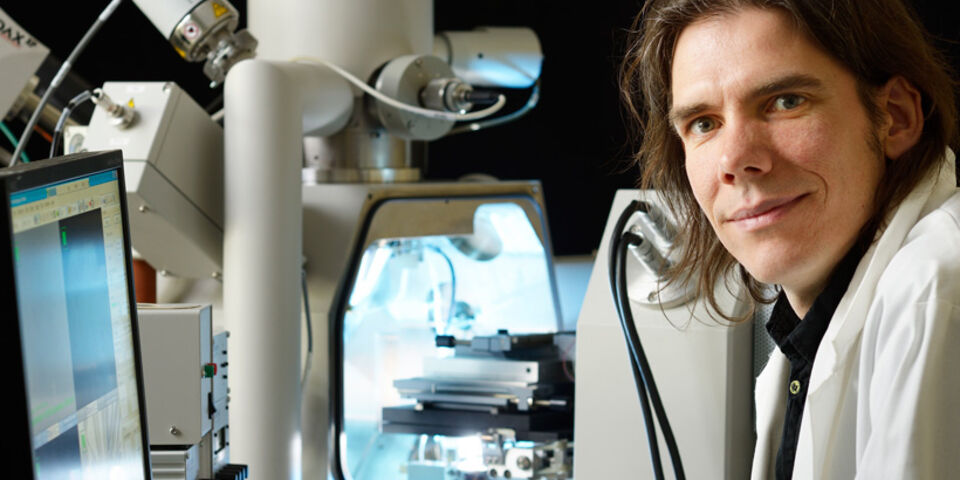 Johan Hoefnagels voor de elektronenmicroscoop met daarin de nanotrekbank. Foto | Bart van Overbeeke