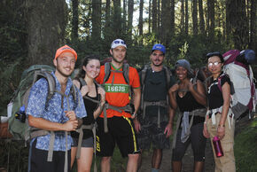 Frans Verbruggen (in orange shirt) hiking.