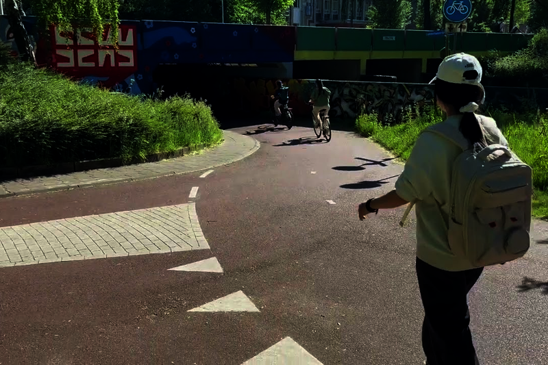 Cyclists and moped riders move crisscross through each other, often at high speeds. Some have to brake, others ring their bells.